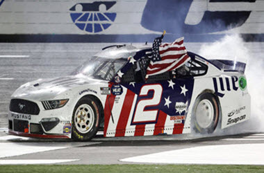 Brad Keselowski takes the checkered flag at the Coca-Cola 600