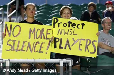 US Soccer fans hold signs demanding action after abuse reports emerge