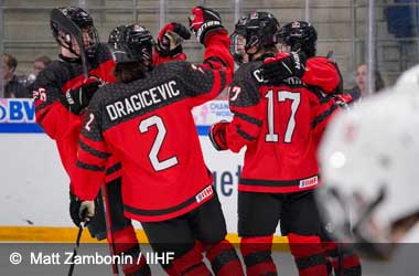 Macklin Celebrini celebrates with team mates after scoring against Switzerland at U18 World Championship 2023