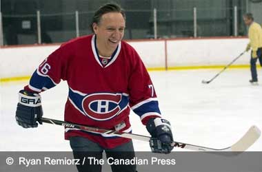 François Legault taking part in a friendly hockey game 
