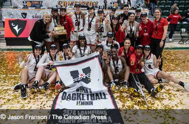 Carleton Ravens celebrate winning the 2024 U Sports Women's Basketball Championship title