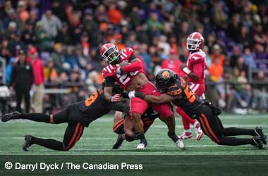 Calgary Stampeders Start Pre-Season Strong with 26-16 Win Over BC Lions Tiyon Evans gets tackled by two BC Lions players during 2025 CFL Pre-Season game