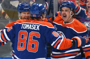 Connor Clattenburg celebrates scoring his first NHL goal with his Edmonton Oilers teammates